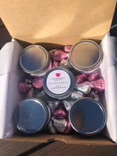 Load image into Gallery viewer, Five candles, each with a different scent, surrounded by chocolate hugs and kisses